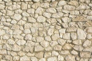 Background of stone wall texture photo. Close-up of stone wall. photo