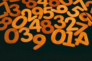 Colorful wooden numbers on a blackboard background with space for text photo