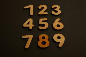 Colorful wooden numbers on black background. Number 1 to 9. photo