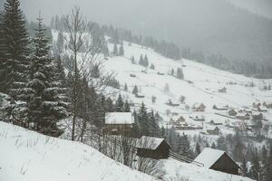 Panorama of the village in the winter mountains covered with snow. Winter landscape. The concept of freedom and solitude. photo