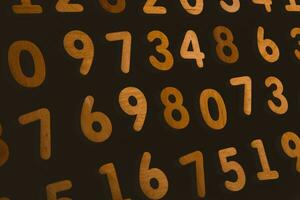 Numbers on a dark background. Seamless pattern. Toned. photo