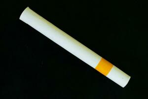 Close up cigarette handmade isolated on black background photo