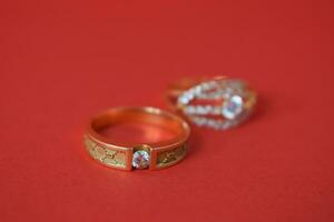 Close Up Golden ring with diamond on isolated red background photo