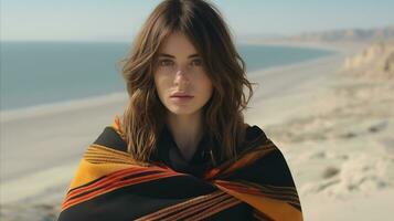 AI generated A woman in a black and orange striped blanket stands on the beach. Generative AI photo