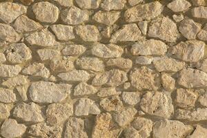 Background of stone wall texture photo. Close-up of stone wall. photo