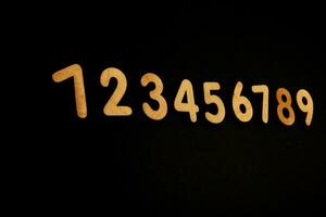 Colorful wooden numbers on black background. Number 1 to 9. photo