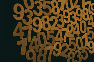 Wooden numbers on a black background. Numbers from zero to nine. photo