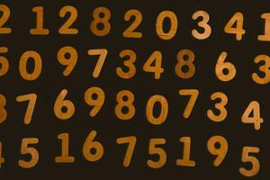 Wooden numbers on a black background. Numbers from zero to nine. photo