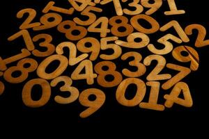 Wooden numbers on a black background. Numbers from zero to nine. photo