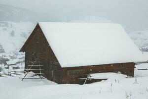 Panorama of the village in the winter mountains covered with snow. Winter landscape. The concept of freedom and solitude. photo