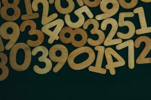 Wooden numbers on a black background. Numbers from zero to nine. photo