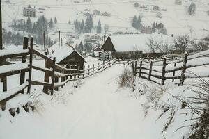 Panorama of the village in the winter mountains covered with snow. Winter landscape. The concept of freedom and solitude. photo