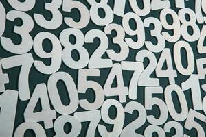 Wooden numbers on a black background. Numbers of different colors. photo