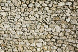 Background of stone wall texture photo. Close-up of stone wall. photo