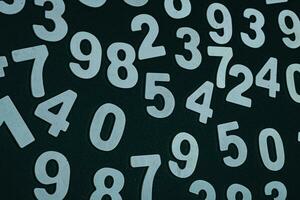 Wooden numbers on a black background. Numbers of different colors. photo