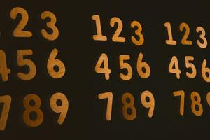 Colorful wooden numbers on black background. Number 1 to 9. photo