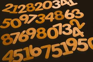 Colorful wooden numbers on a blackboard background with space for text photo