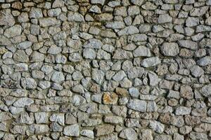 Background of stone wall texture photo. Close-up of stone wall. photo