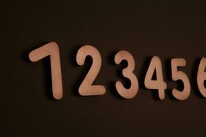 Colorful wooden numbers on black background. Number 1 to 9. photo