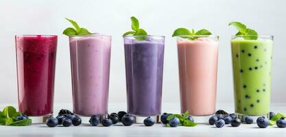 AI generated several drinks with purple berries, mint and blue smoothie on a white background photo