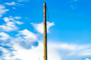 Power electric pole with line wire on colored background close up photo