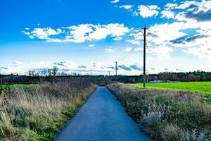 Beautiful empty asphalt road in countryside on colored background photo