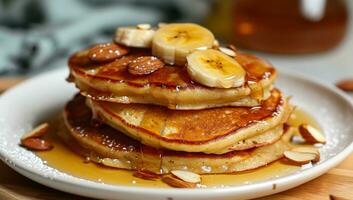 AI generated a plate of pancakes with bananas and almonds photo