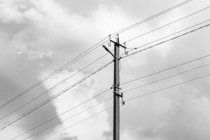 Power electric pole with line wire on light background close up photo