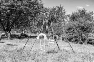 Photography on theme empty playground with metal swing for kids photo