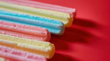 AI generated a close up of some colored cotton candy sticks against a red background photo