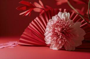 AI generated on a red background a fan holds a pink flower photo