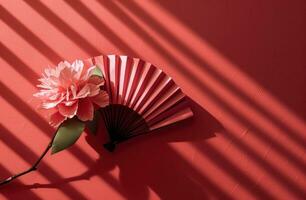 AI generated on a red background a fan holds a pink flower photo