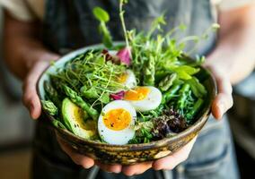 AI generated hand held image of someone holding a bowl of greens, eggs photo