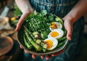 AI generated hand held image of someone holding a bowl of greens, eggs photo