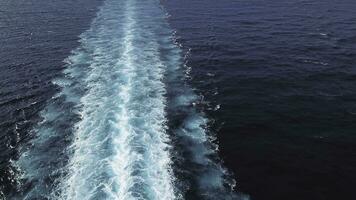 Aerial top view of a beautiful rail on the sea or ocean surface behind of speed cruise liner. Stock. Wake in the ocean made by large ship. photo