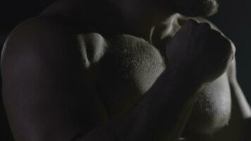 Boxing man ready to fight. Boxer with strong hands and clenched fists on a black background. Close-up of hand of boxer ready for a fight. photo