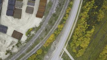 Top view of the industrial area located near the yellow forest, autumn nature. Clip. Aerial view of warehouses and the road near industrial zone. photo