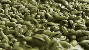 Close up of unroasted coffee beans background. Stock footage. A pile of many green unroasted ethiopian coffee seeds for the beverage preparation. photo