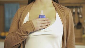 Woman checks the temperature of the milk. Caring mother checks the temperature of milk from a bottle photo