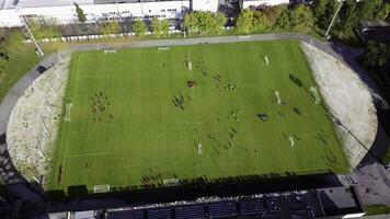 Football players running around the football field. Top view of the football youth tournament photo