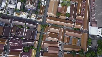 Nice view from the top of houses with tiled roofs. Top view of modern and old houses of the city. Cityscape of town and city from top view. Old and modern architecture of different styles. Authentic photo