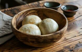 AI generated three chow mein style buns sit in a wooden bowl photo