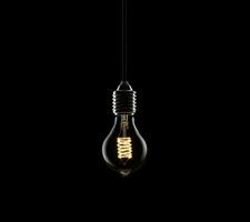 AI generated a light bulb is illuminated on a dark background photo