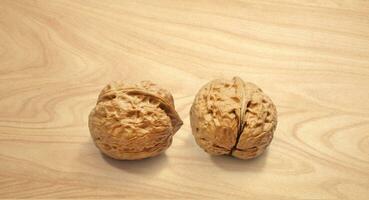 Walnuts on wooden background, front view photo