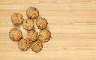 Walnuts on wooden background. Top view. photo