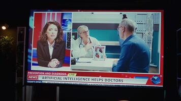 Close up of medical AI news discussed by presenter, displayed on smart TV in empty dark apartment. Newscast headline about artificial intelligence on video on demand channel, panning shot