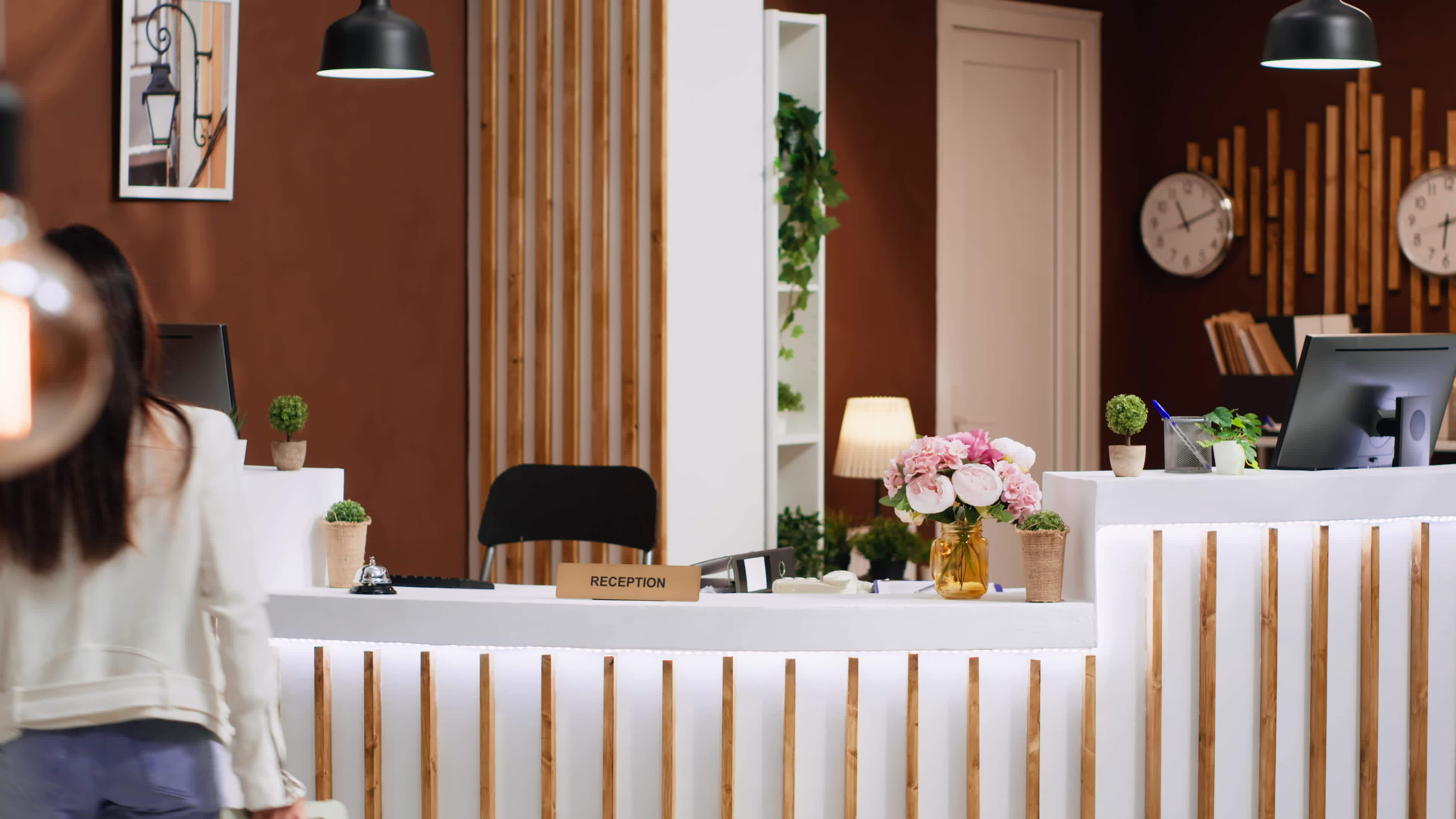 Hotel guests using service bell for assistance at front desk, calling