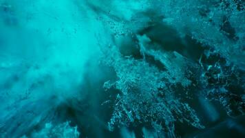 Majestic ice rocks in vatnajokull caves, transparent blue blocks of ice melting after global warming in iceland. Climate change affecting icelandic glaciers and polar nature. Handheld shot. photo