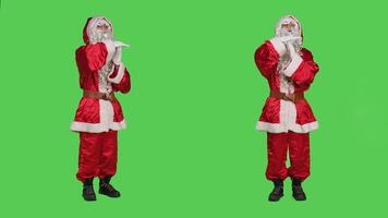 Saint nick feeling exhausted in studio, showing timeout symbol to express burnout while he is overworked. Winter festive character in red costume being tired, rejecting work on greenscreen. photo