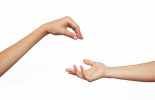 Female hand makes a gesture like handing some kind of hanging object as keys to the other outstretched hand isolated on a white background. Mockup with empty copy space for a intended object. Handover photo